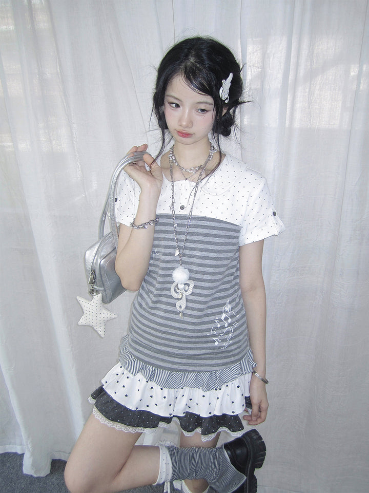 Gray striped and white polka-dot Peter Pan collar top with a layered star-print skirt and a silver shoulder bag.